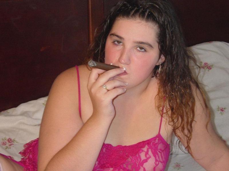 20P Chubby babe casually smoking large cigar on bed