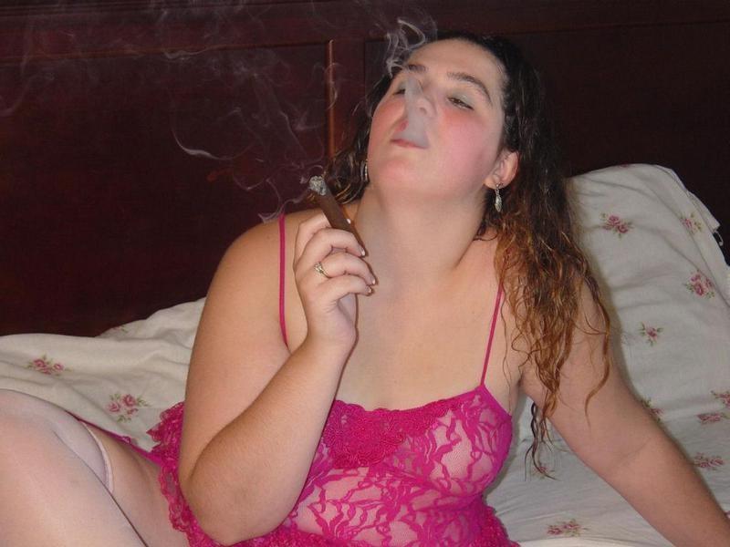 20P Chubby babe casually smoking large cigar on bed
