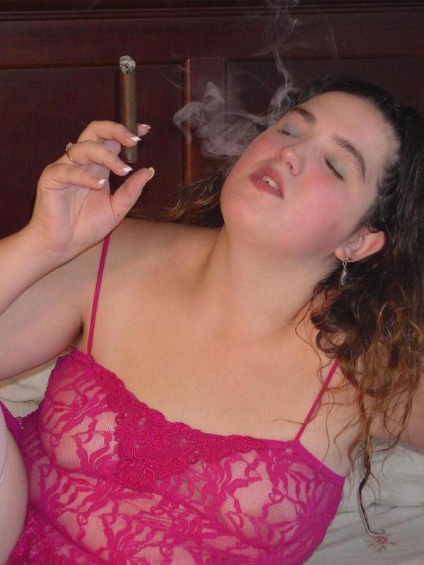 20P Chubby babe casually smoking large cigar on bed