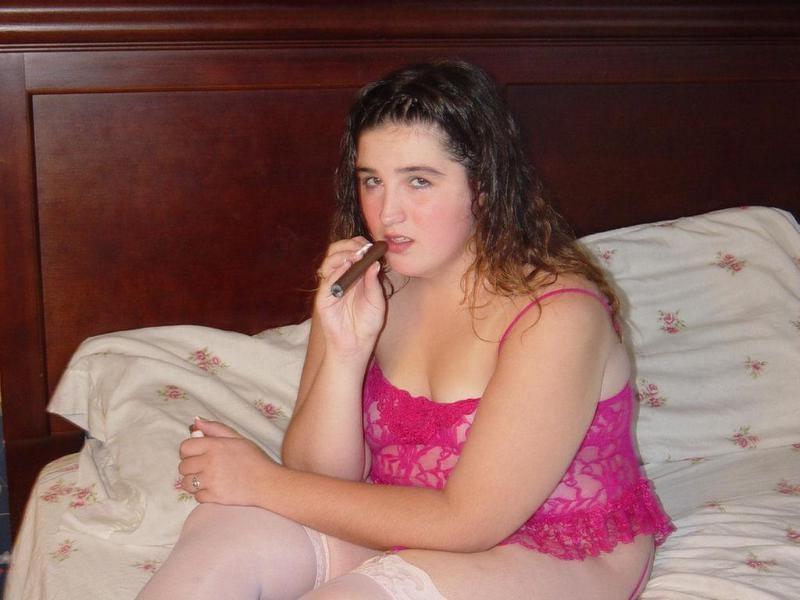 20P Chubby babe casually smoking large cigar on bed