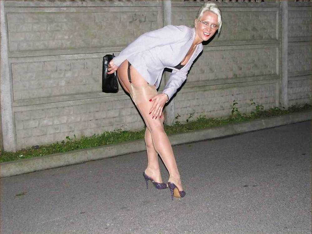 25P Blonde shows her legs in stockings 4