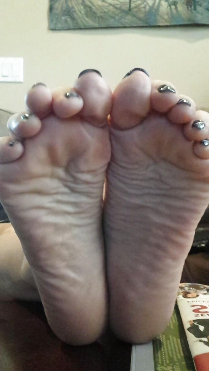 12P Sexy soles propped up on the table. 