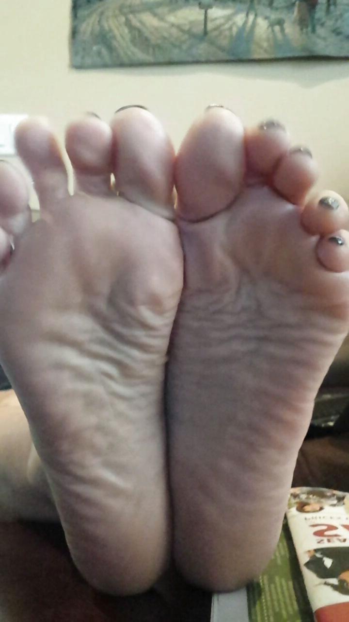 12P Sexy soles propped up on the table. 