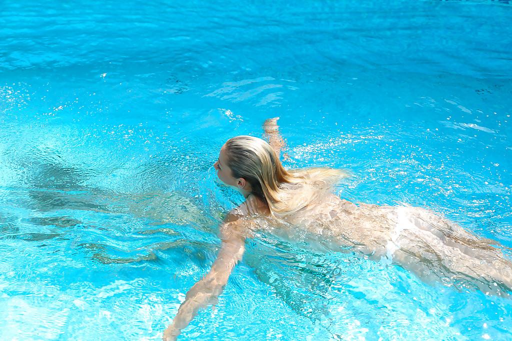 16P Young blonde Christen is swimming in the pool naked and masturbating