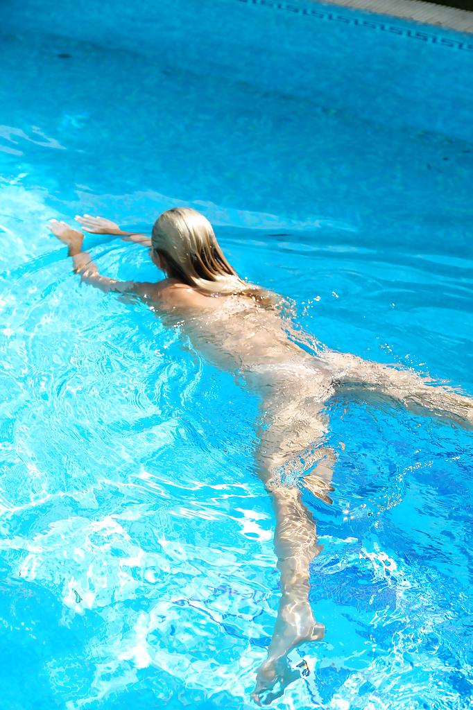 16P Young blonde Christen is swimming in the pool naked and masturbating