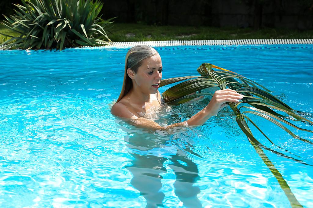 16P Young blonde Christen is swimming in the pool naked and masturbating