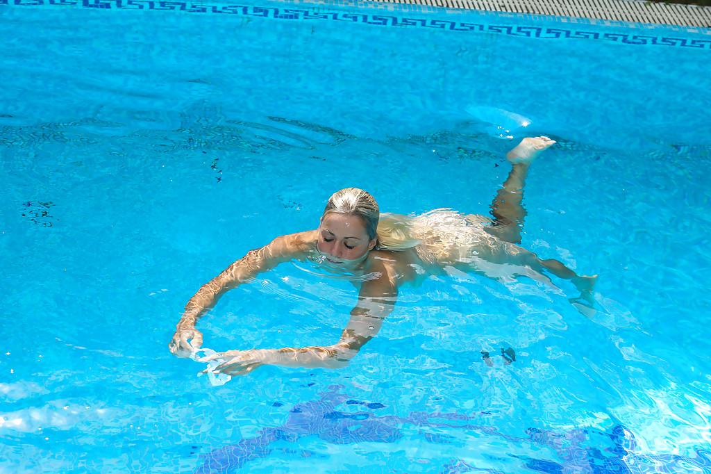 16P Young blonde Christen is swimming in the pool naked and masturbating