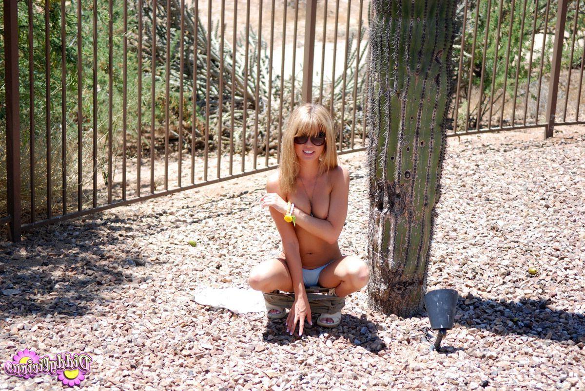 20P Pictures of Diddylicious stripping to her underwear outside
