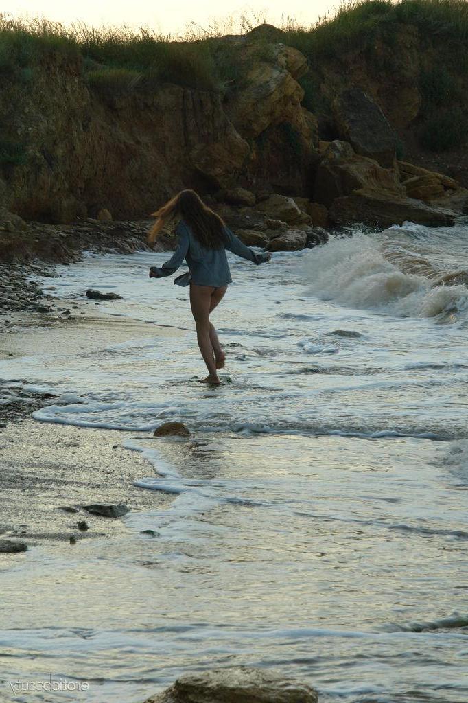 16P Brunette teen Petra E gets naked on the beach in "Surf In"