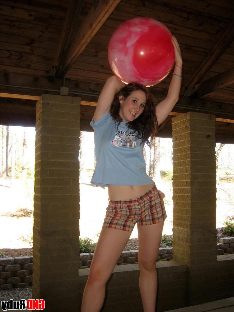 12P Ginger teen Ruby flashes her perky tits at the park while playing with a pink ball