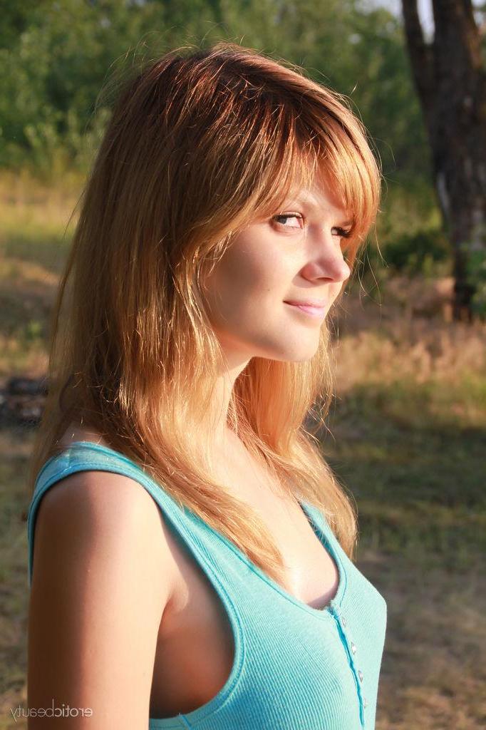 16P Redhead teen Agni A gets naked on the beach in "Warm Sensation"