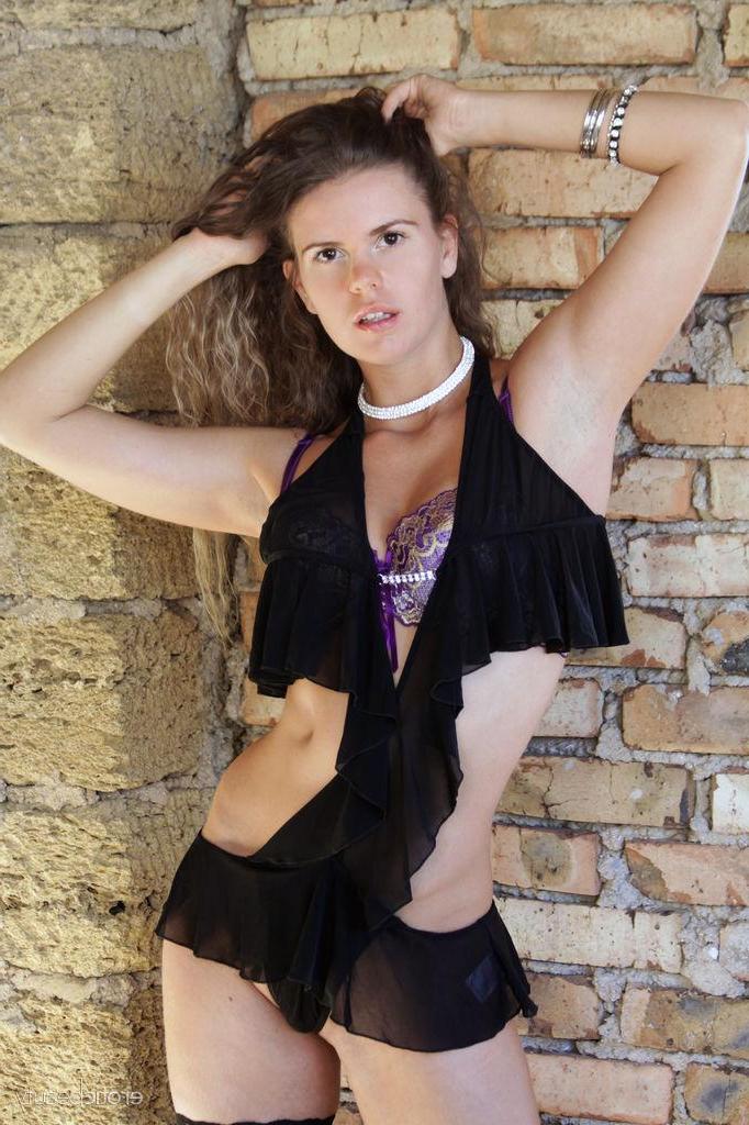 16P Nik poses outdoors with her black stockings and long sexy legs