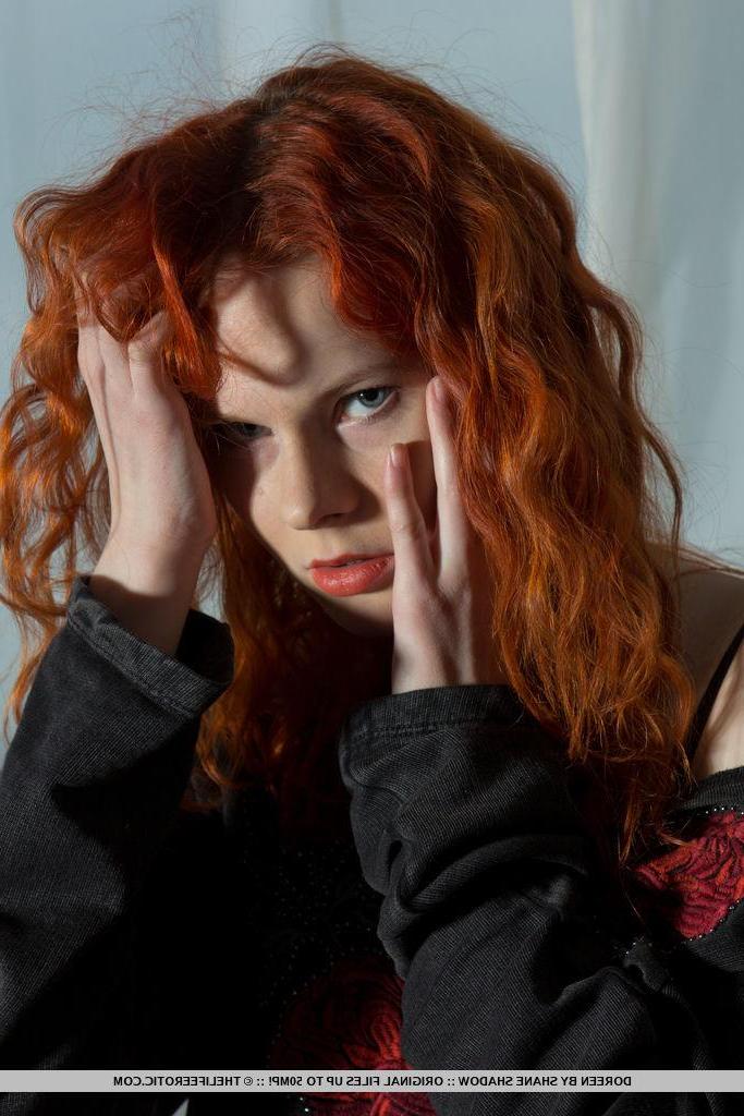 16P Redhead pin up Doreen strips naked and shows you her tight pussy
