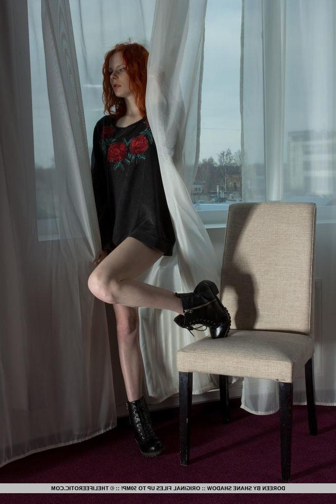 16P Redhead pin up Doreen strips naked and shows you her tight pussy