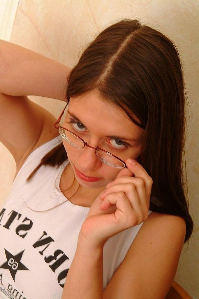 15P Cute girlfriend wearing glasses and posing in her bed