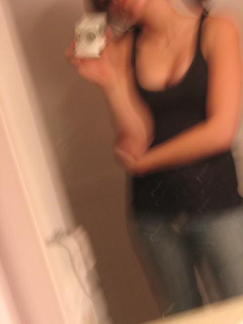 10P Babe poses half naked before her own camera