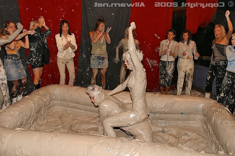15P Hot babes tearing off their tops while wrestling in the mud