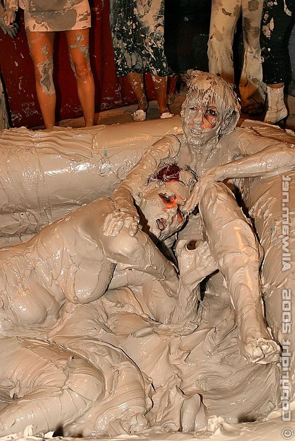 15P Hot babes tearing off their tops while wrestling in the mud