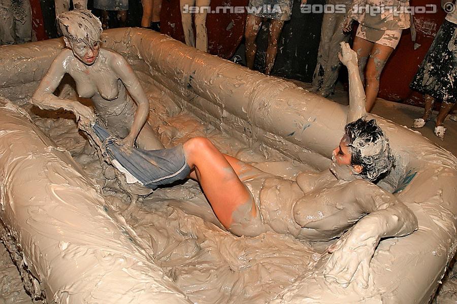 15P Hot babes tearing off their tops while wrestling in the mud