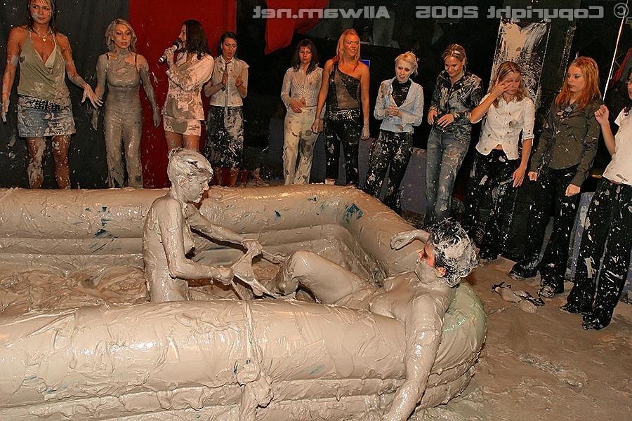 15P Hot babes tearing off their tops while wrestling in the mud