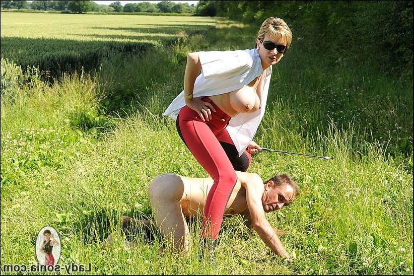 15P A busty whip mistress is abusing her male slave in the open