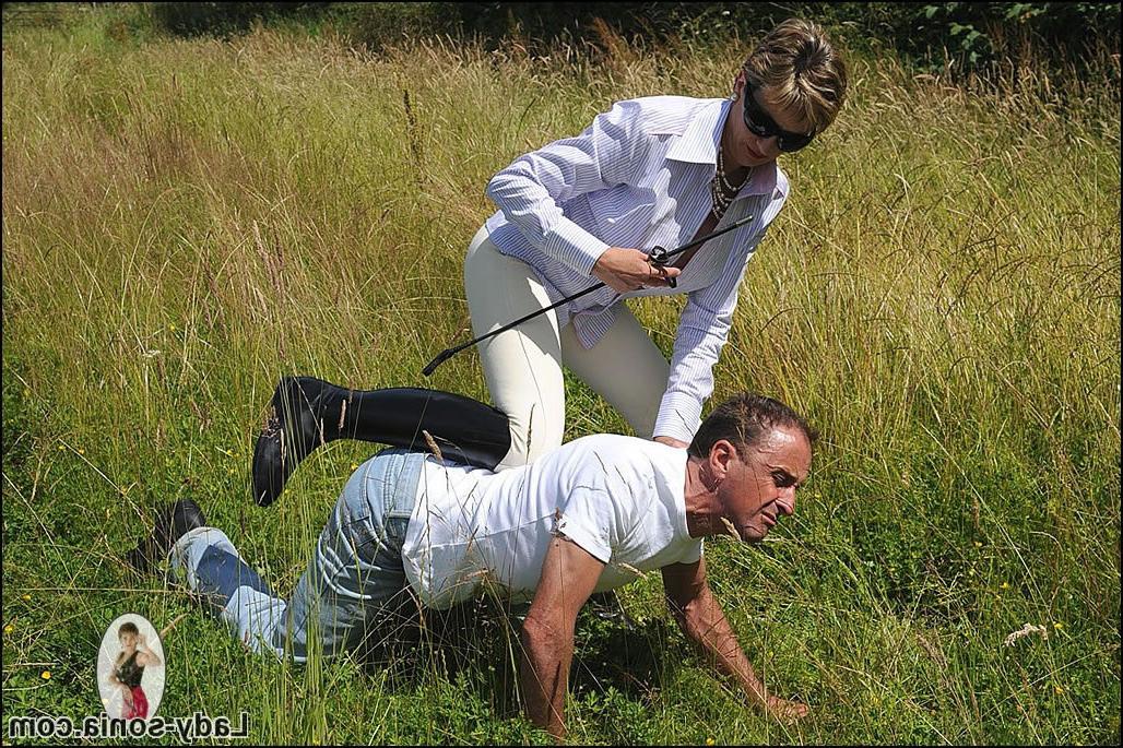 15P English equestrian mistress in riding boots outdoors with slave
