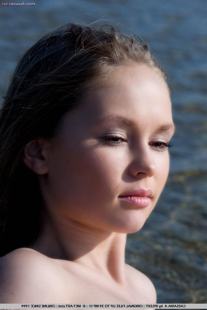 15P Erotic petite teen posing nude on the beach