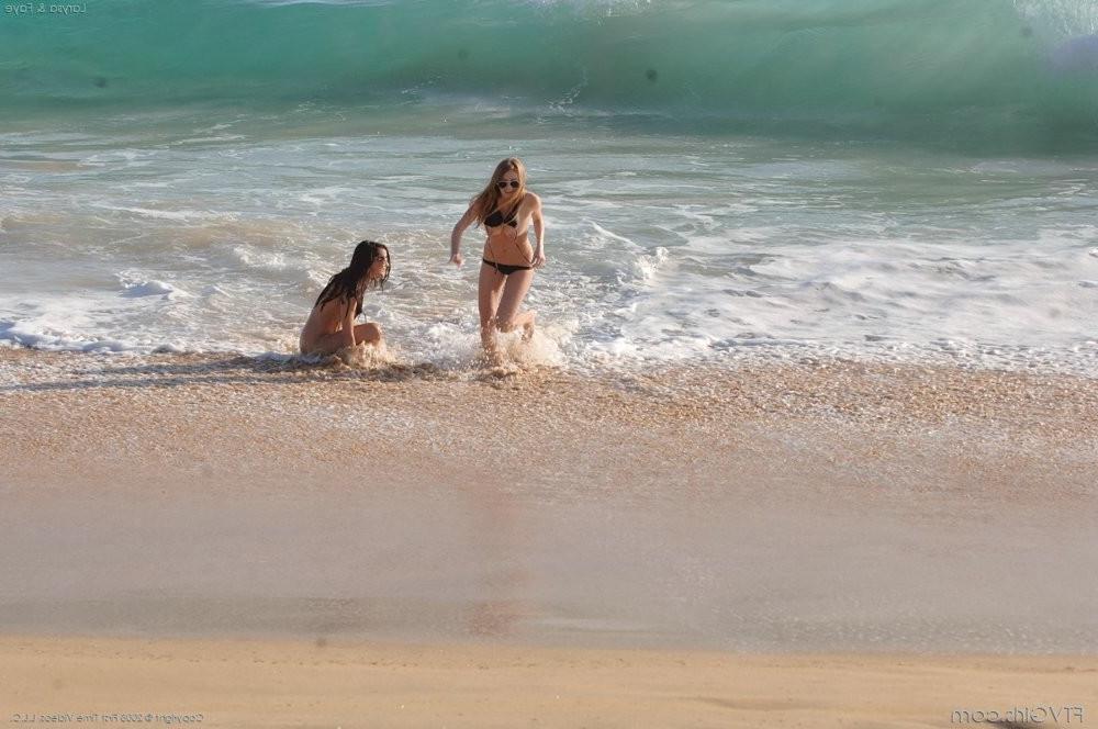 15P Two hot sexy bikini babes flashing their racks on a sandy beach