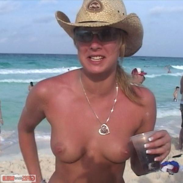 10P Young topless babe on the beach drinking a beer