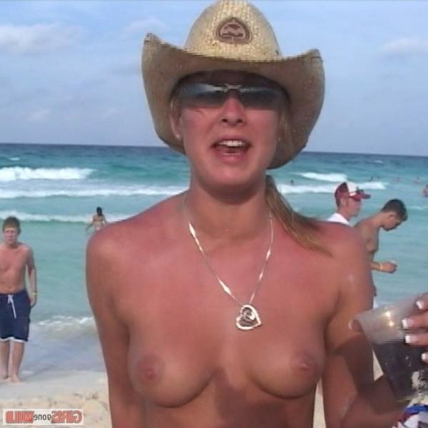 10P Young topless babe on the beach drinking a beer