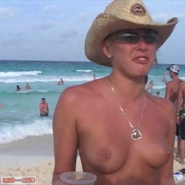 10P Young topless babe on the beach drinking a beer