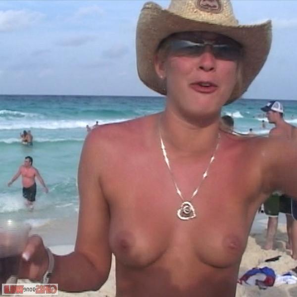 10P Young topless babe on the beach drinking a beer