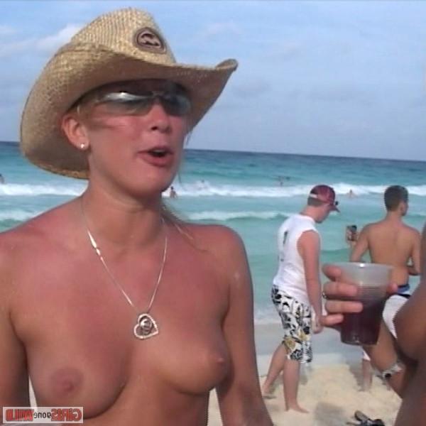 10P Young topless babe on the beach drinking a beer