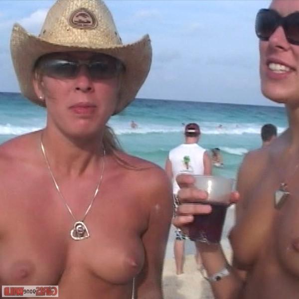 10P Young topless babe on the beach drinking a beer