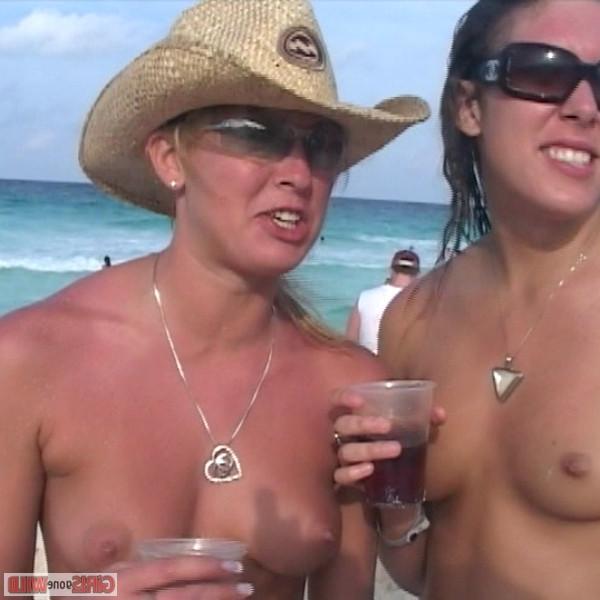 10P Young topless babe on the beach drinking a beer