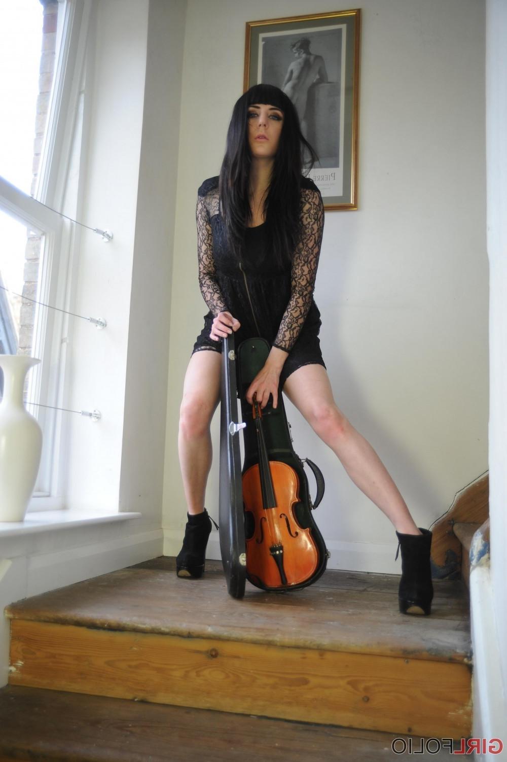12P Leggy brunette stripping and posing with her violin