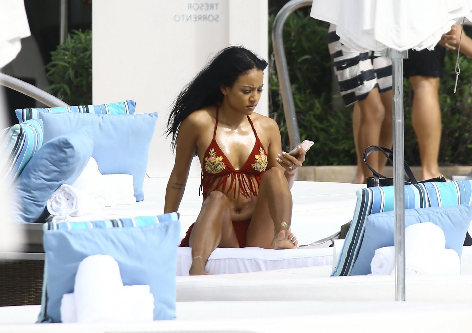 16P Karrueche Tran busty and booty in tiny red bikini poolside