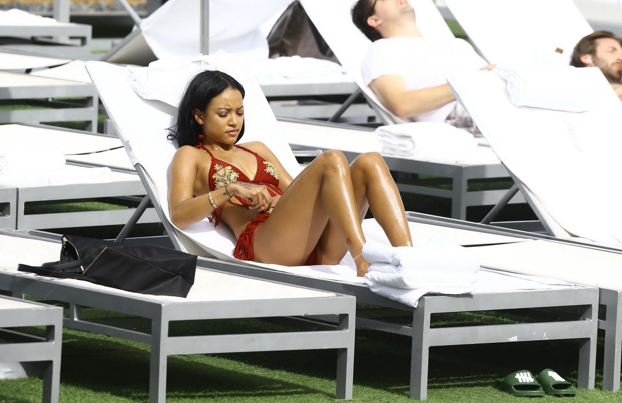 16P Karrueche Tran busty and booty in tiny red bikini poolside