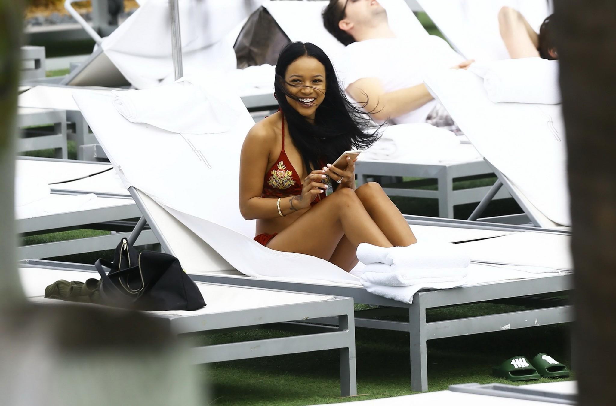 16P Karrueche Tran busty and booty in tiny red bikini poolside