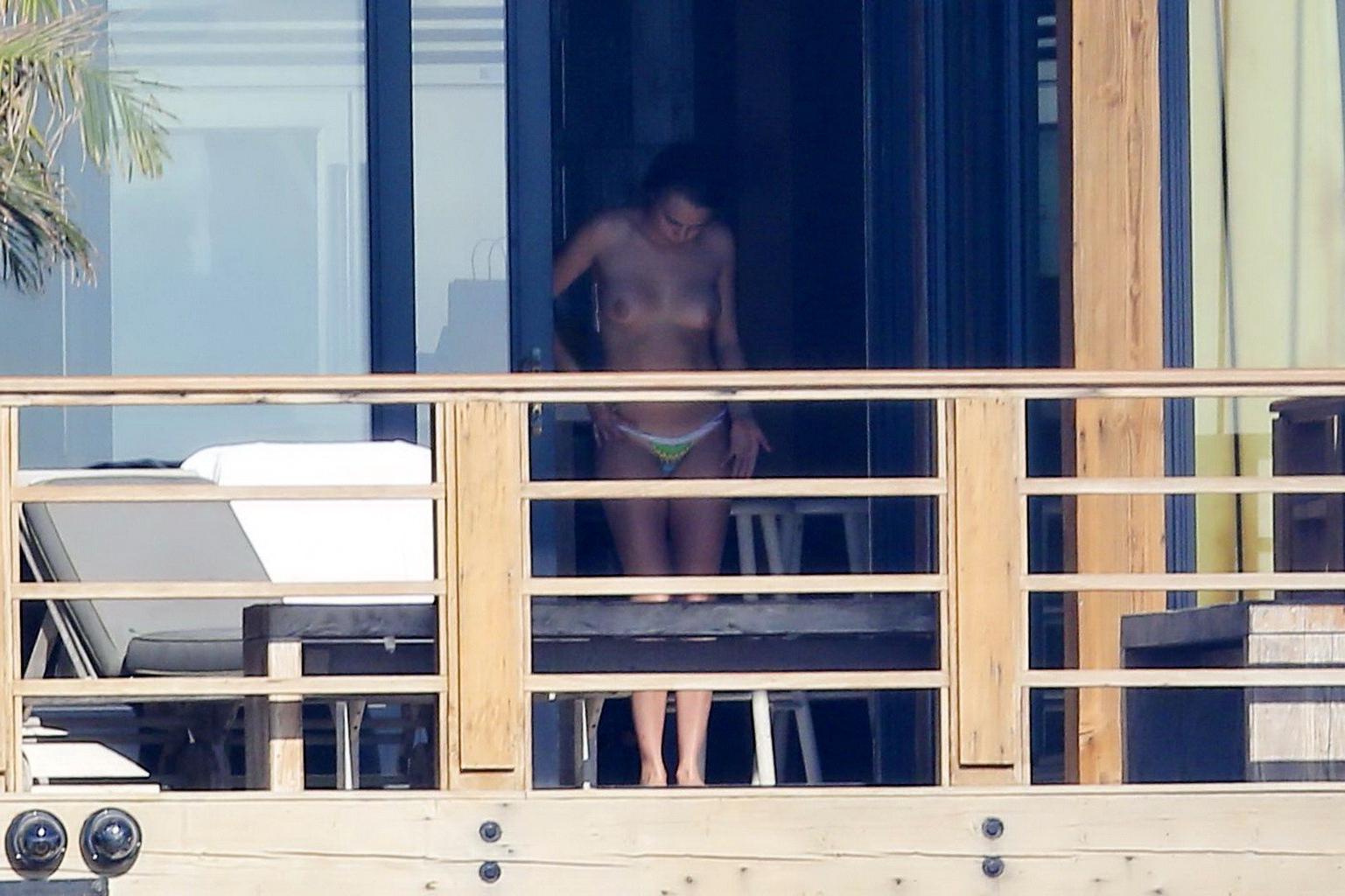 16P Cara Delevingne tanning topless on a balcony in Malibu