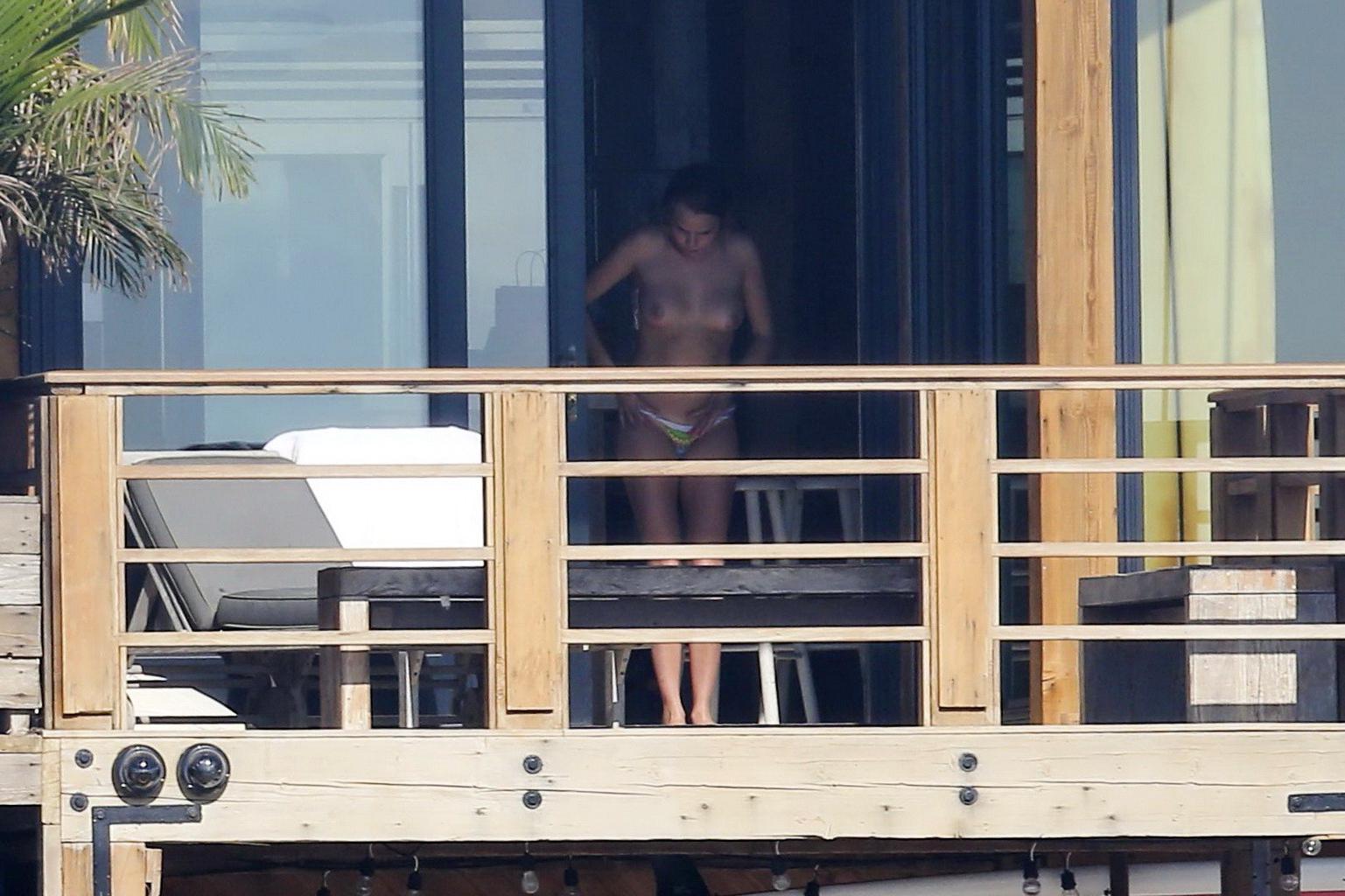 16P Cara Delevingne tanning topless on a balcony in Malibu