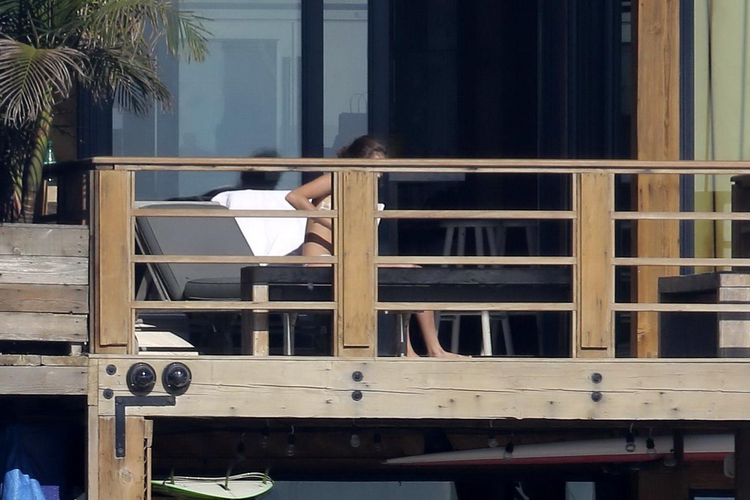 16P Cara Delevingne tanning topless on a balcony in Malibu