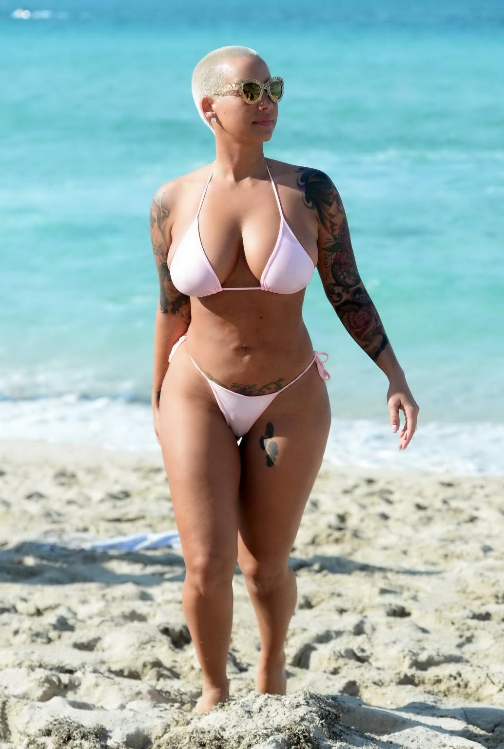 16P Amber Rose busty and booty wearing string bikini at the beach in Miami