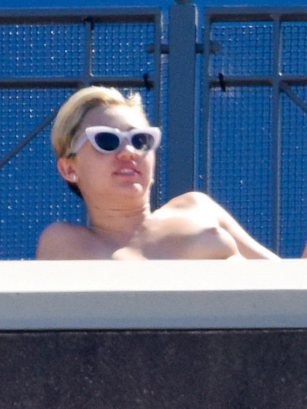 13P Miley Cyrus tanning topless at the hotel balcony in Sydney
