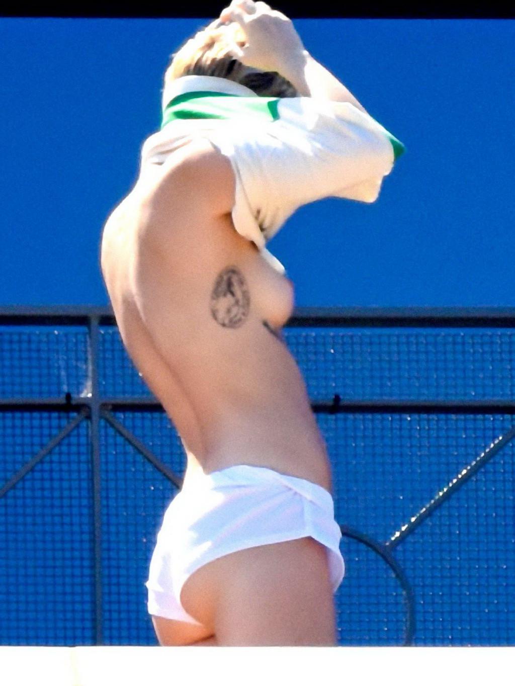 13P Miley Cyrus tanning topless at the hotel balcony in Sydney