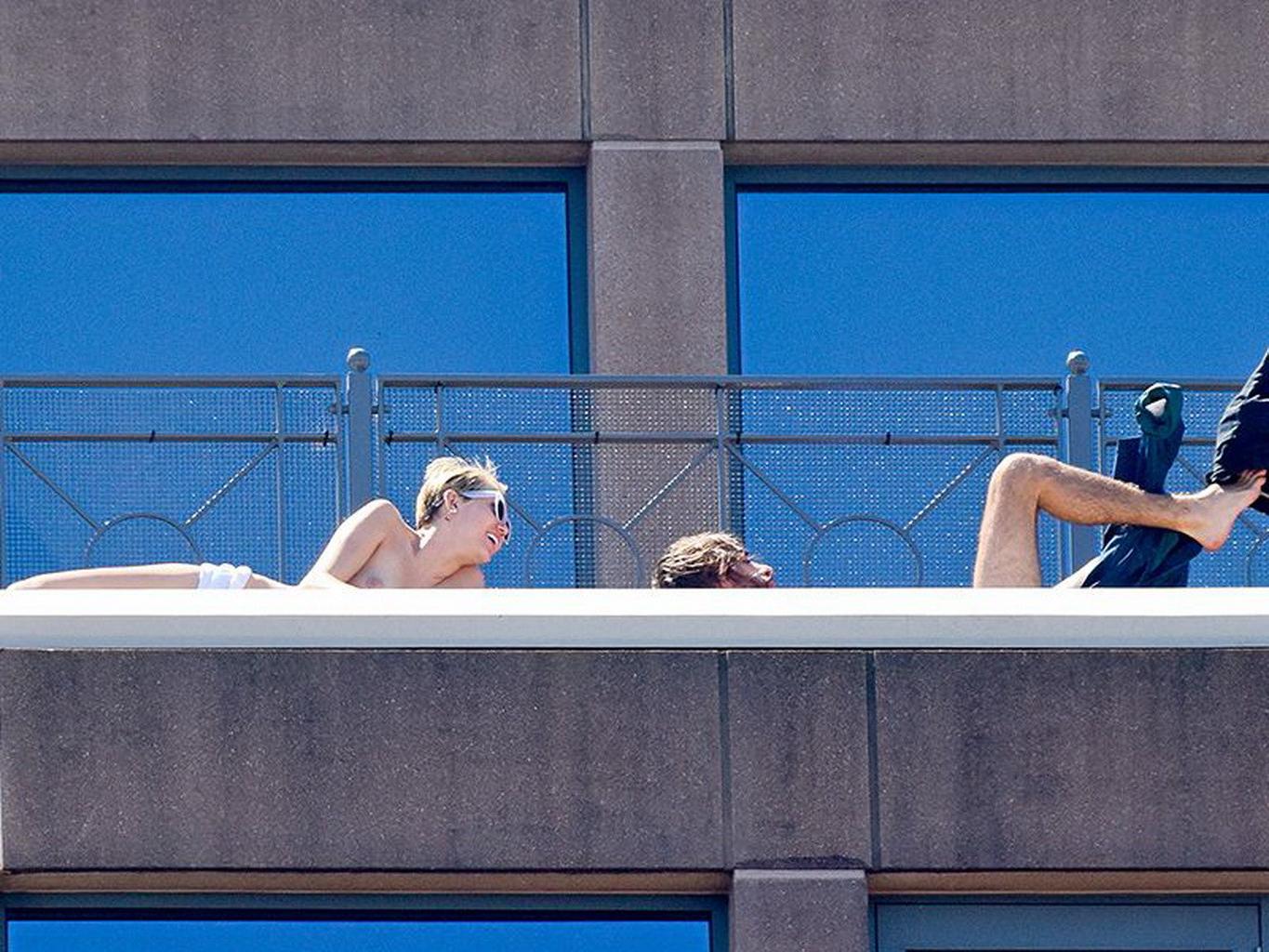 13P Miley Cyrus tanning topless at the hotel balcony in Sydney