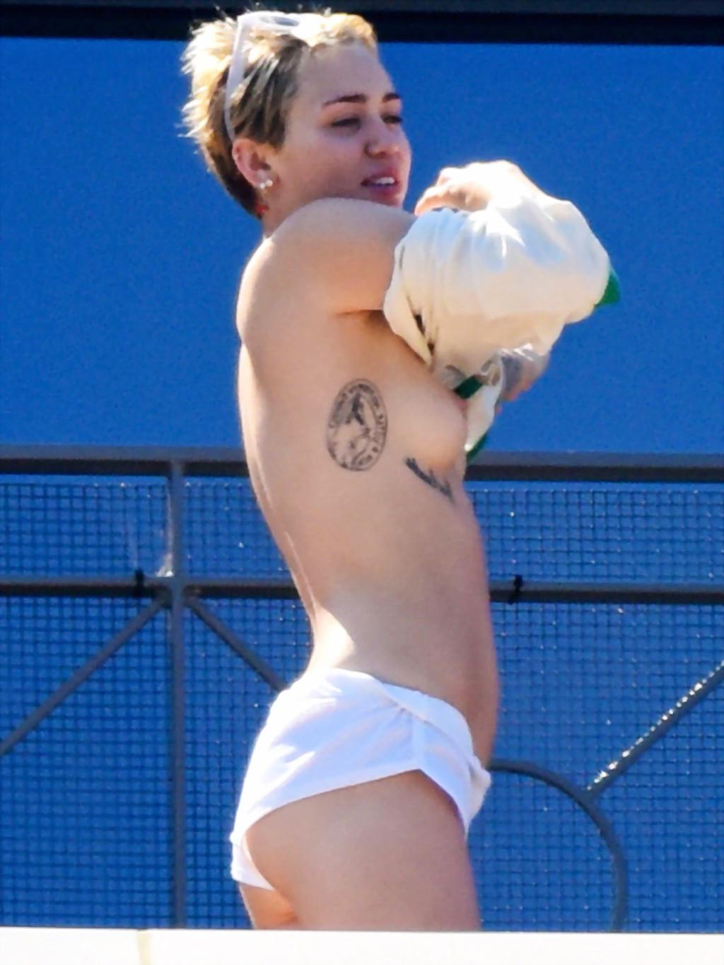 13P Miley Cyrus tanning topless at the hotel balcony in Sydney