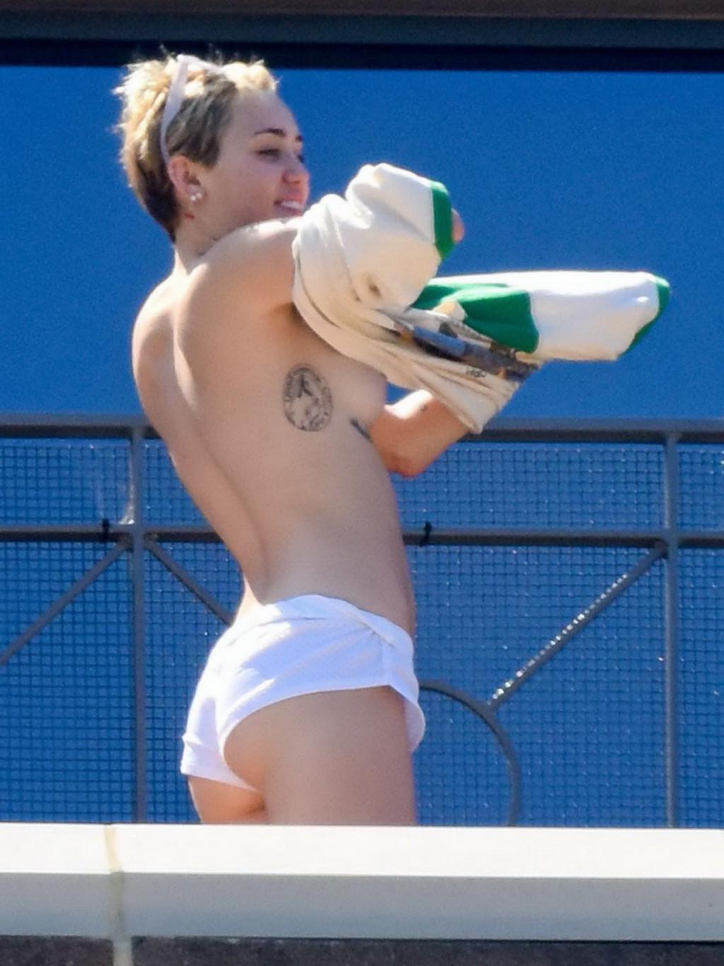 13P Miley Cyrus tanning topless at the hotel balcony in Sydney
