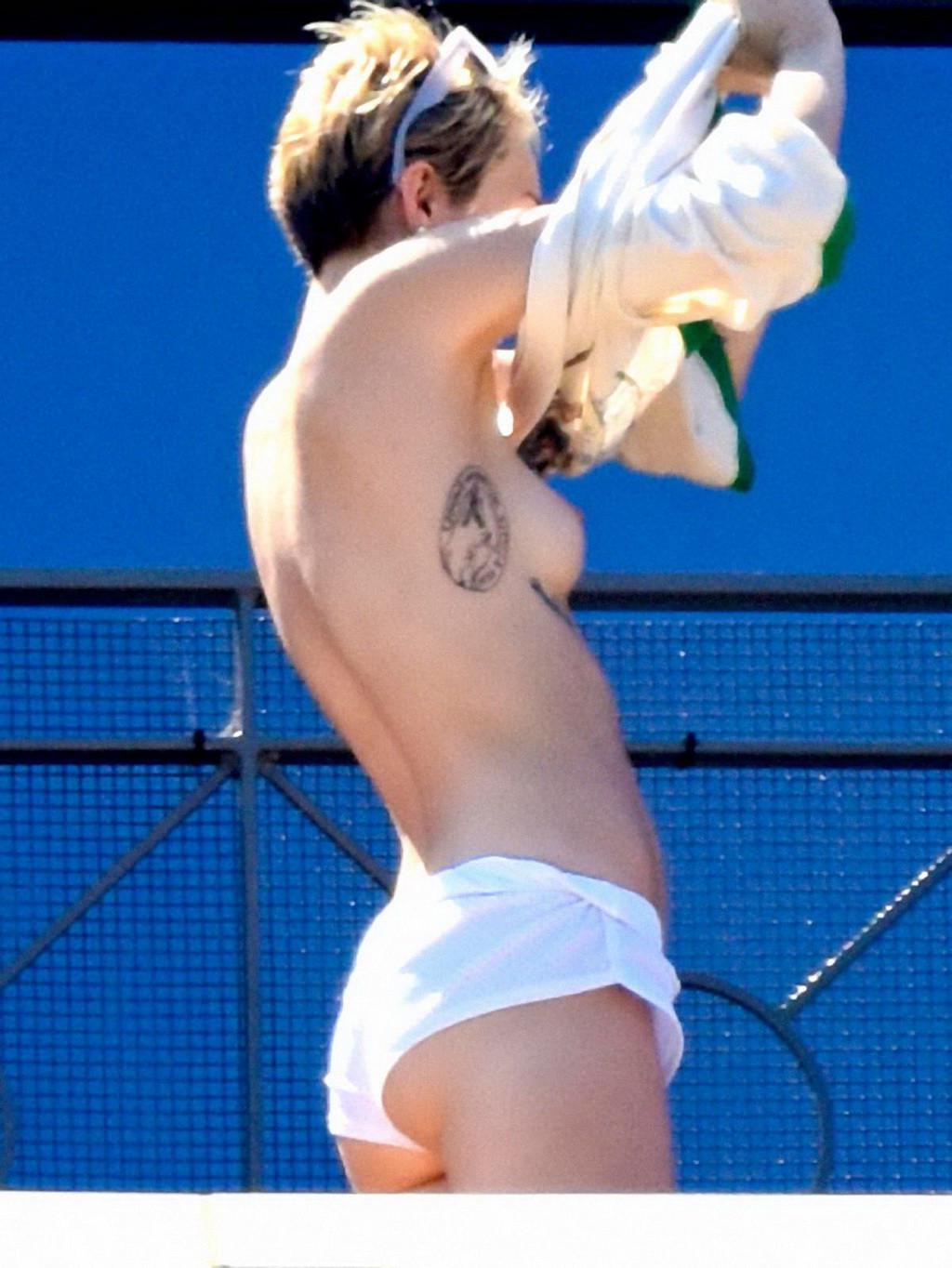 13P Miley Cyrus tanning topless at the hotel balcony in Sydney