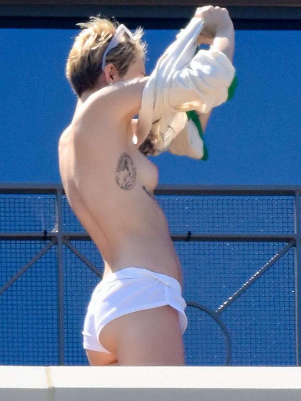 13P Miley Cyrus tanning topless at the hotel balcony in Sydney